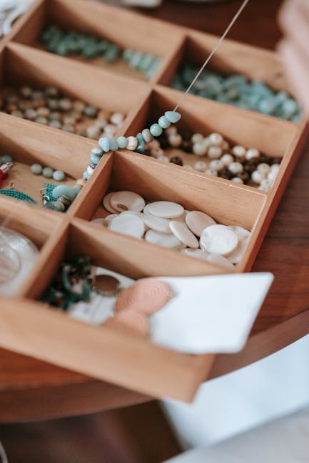 A wooden tray with assorted beads, perfect for crafting and jewelry making.